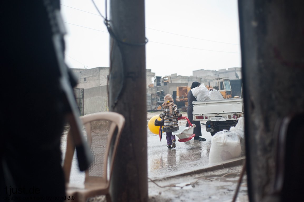 Aleppo – Girl with a yellow balloon in a destroyed neighborhood